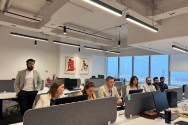 Board discussing cost reduction versus value creation in a bright modern meeting room