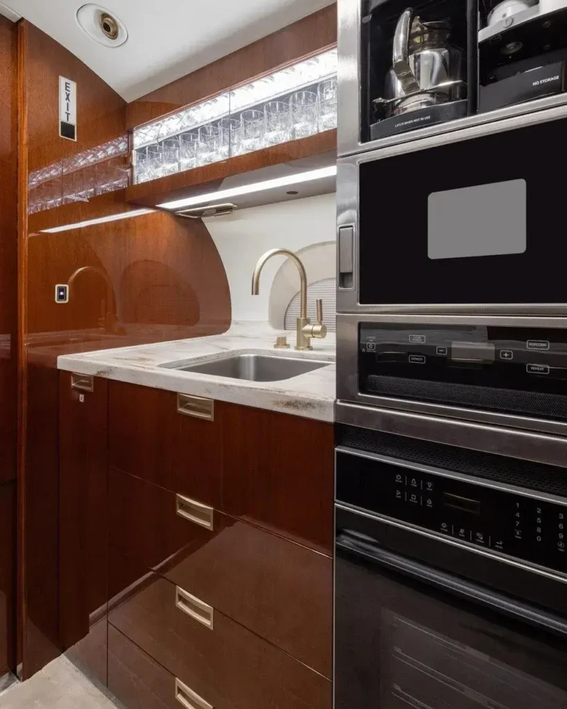 Gulfstream G650ER luxury galley interior with storage, work surfaces and appliances